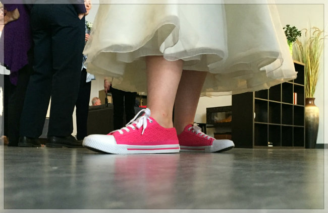 Pink sneakers in a wedding dress for a sporty wedding